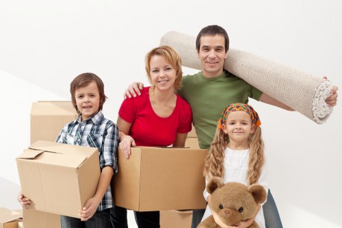 Packed boxes and household items ready for transport by man and van