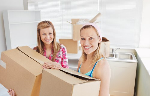 Professional movers handling a sofa and table for a Hounslow move